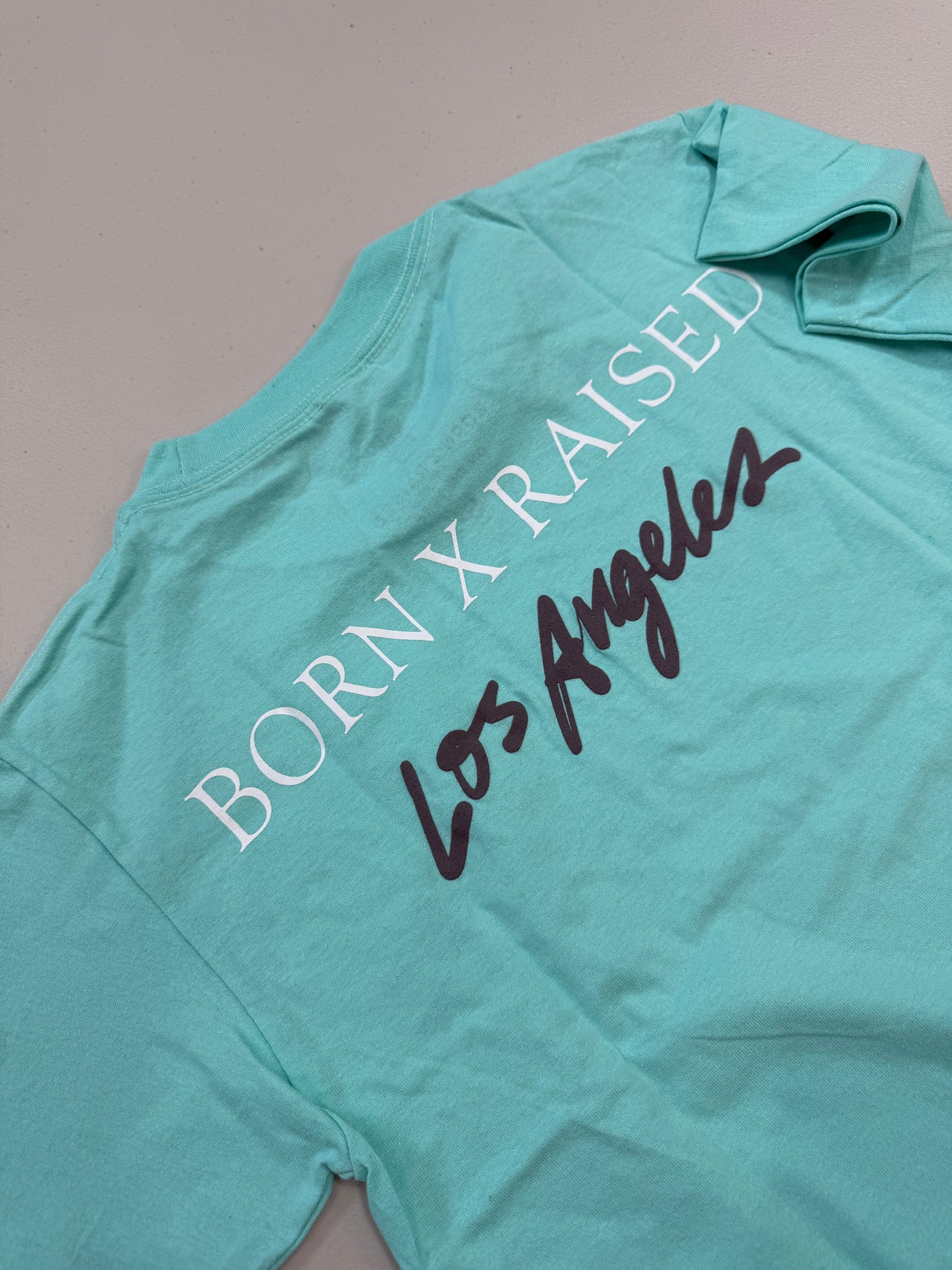 BORN X RAISED ON THE TURF BXR LA TEE (TEAL)